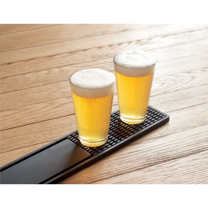 Branded bar runner mat on a bar counter with beer glasses