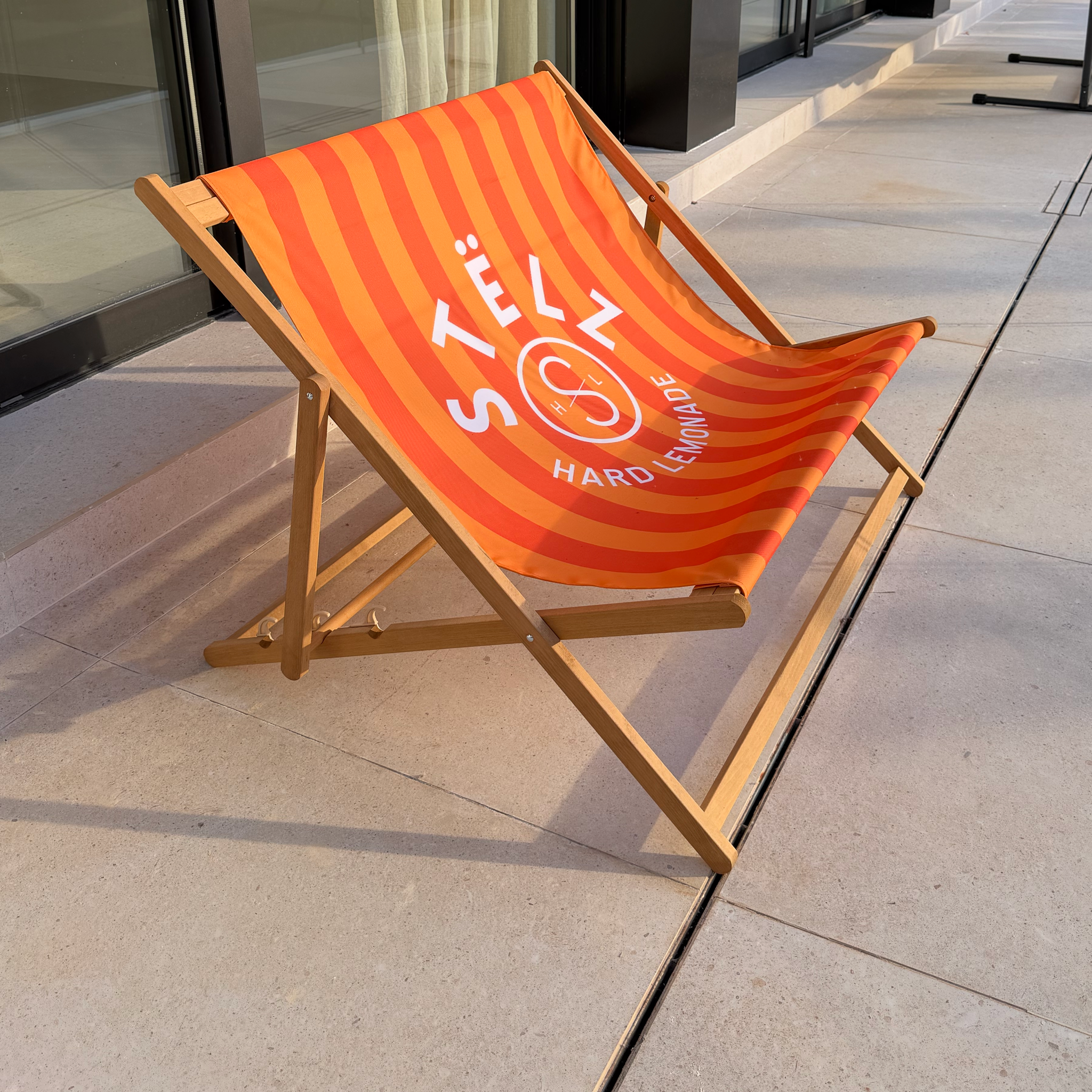 Custom printed double deck chair lifestyle photo with orange logo fabric