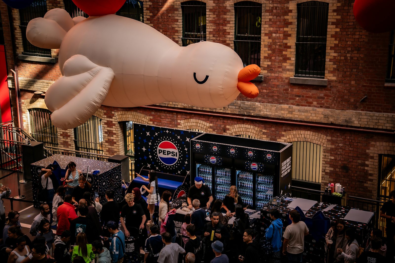 Material promocional de Pepsi con refrigeración personalizada en un evento concurrido